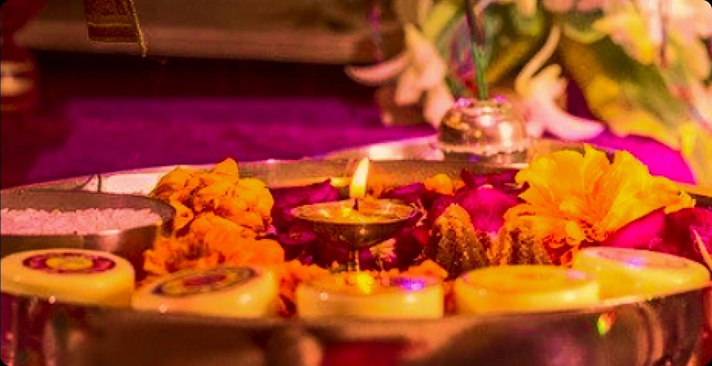 Puja ceremony with flowers and candles